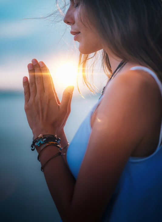 Calm woman with hands folded.